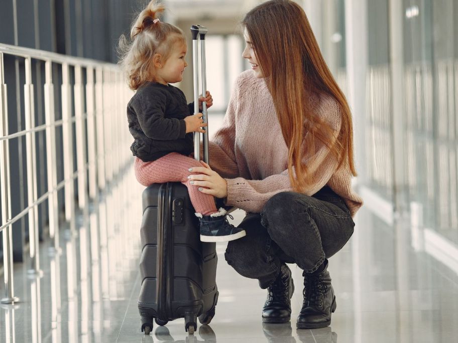 Child riding on luggage at an Airport