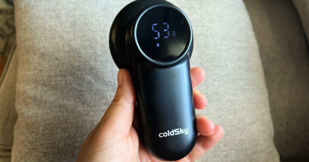 person holding black ColdSky Fabric shaver