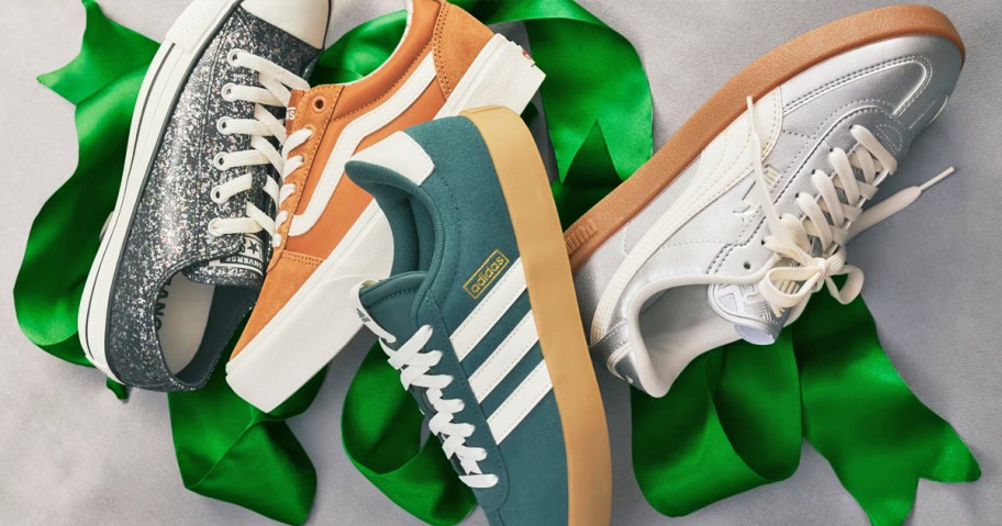 converse, vans, adidas, and puma sneakers with a green ribbon behind them