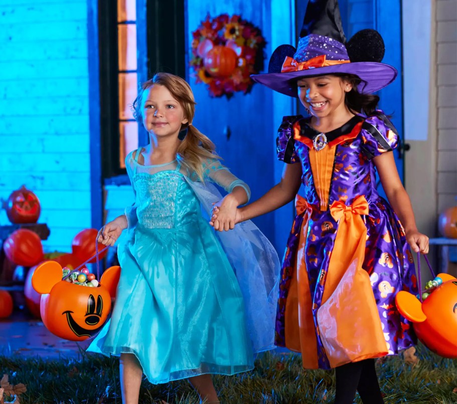 two girls wearing elsa and disney witch costumes