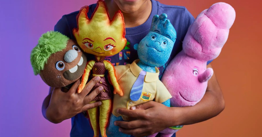 little boy holding multiple plushes