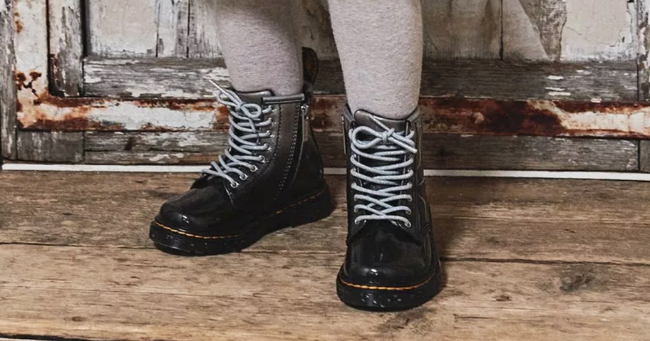 girl wearing grey and black lace up boots