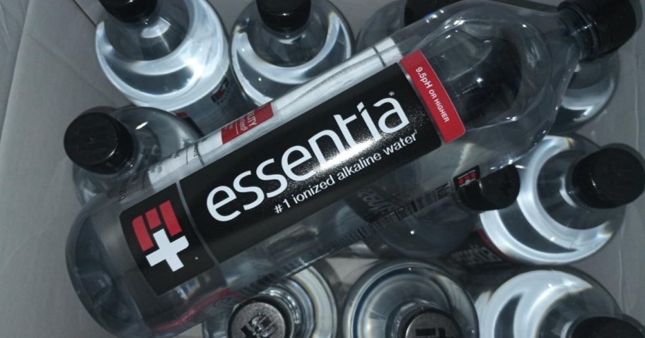 bottle of essentia water on top of other bottles of water
