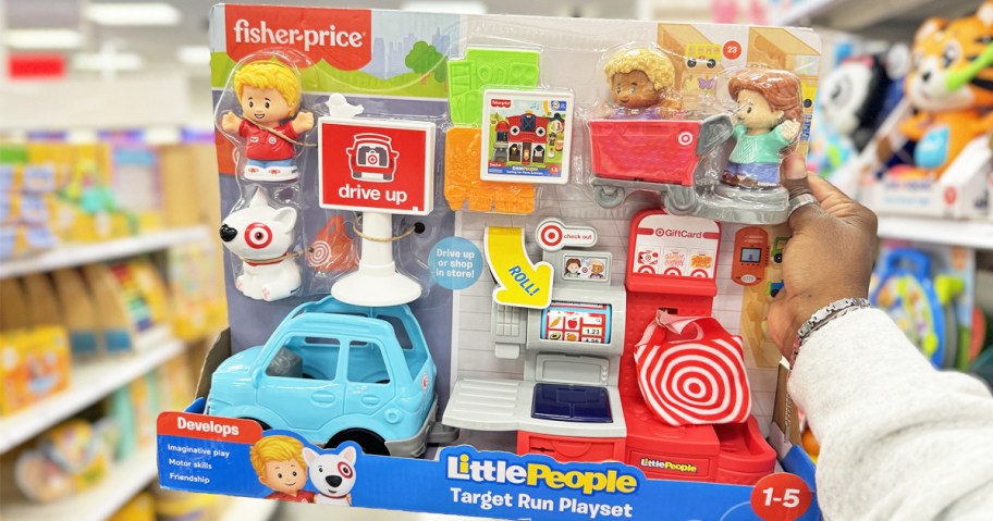 hand holding up Fisher-Price Little People Target Run Playset in store