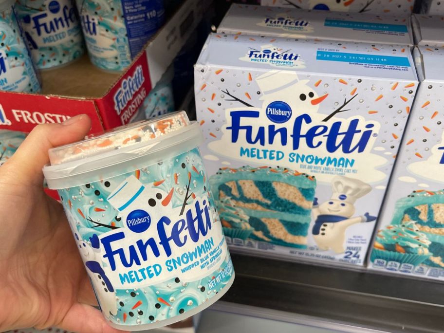 hand holding Funfetti Melted Snowman Swirl Cake