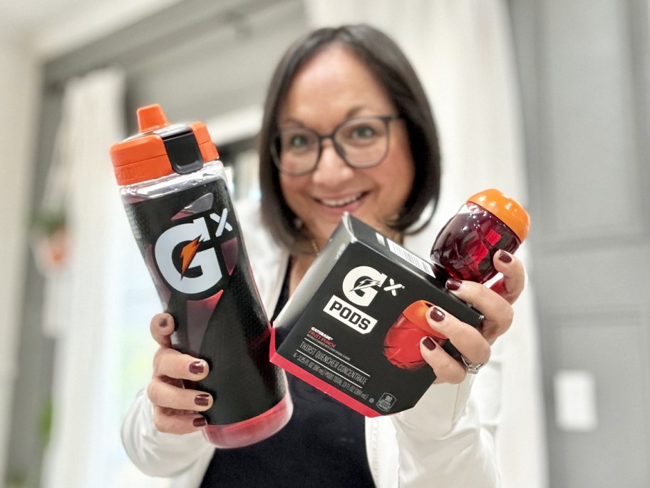 woman holding up gatorade bottle and box of gatorade pods