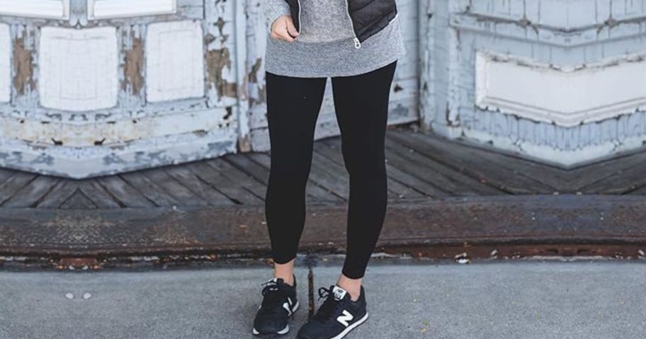 Woman wearing leggings with a tunis and retro style new balance sneakers