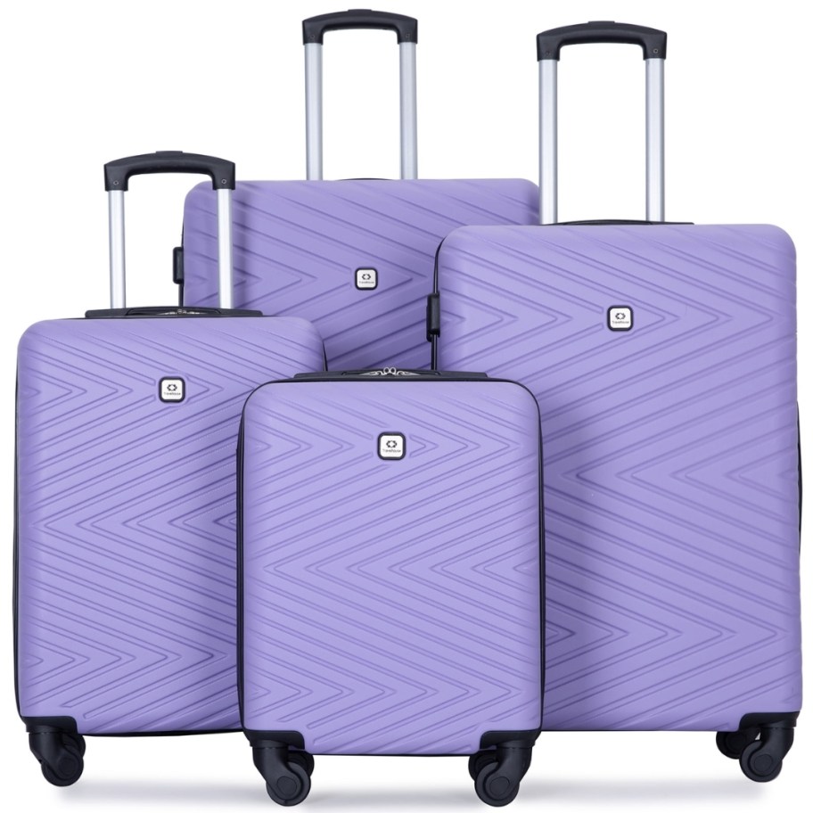 a set of 4 pieces of hardsided spinner luggage pieces in various sizes in a light purple color