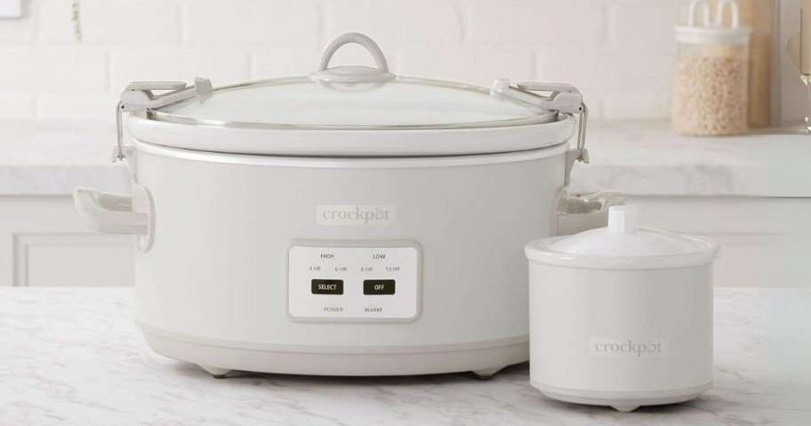 a tan color large Crockpot with locking lid and a matching smaller Little Dipper Crockpot on a kitchen counter