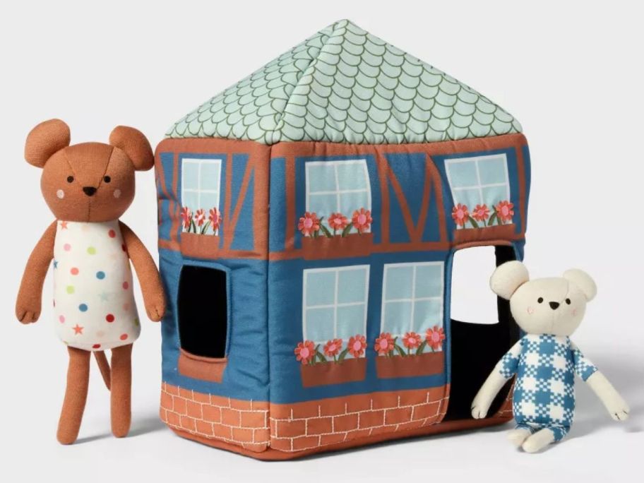 a plush toy house with plush mice stuffed animals next to it