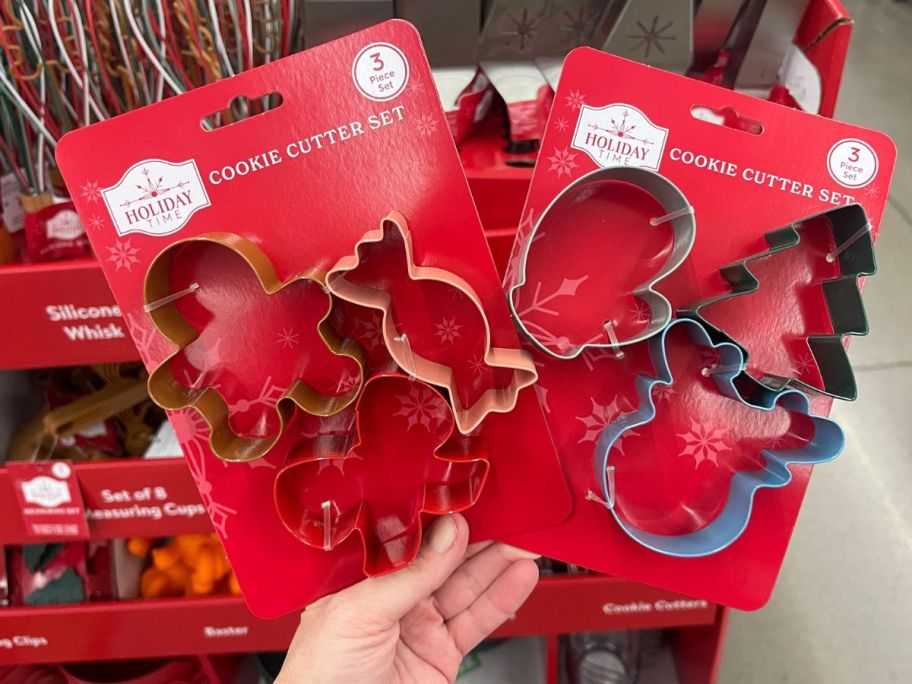 hand holding two Holiday Time 3-Piece Cookie Cutters different designs