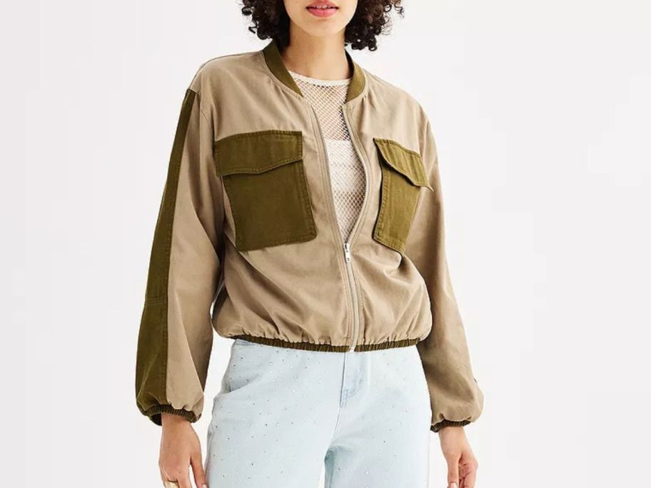 A woman wearing a INTEMPO Women's Cargo Bomber Jacket