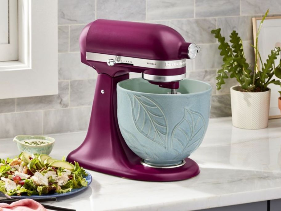 A KitchenAid mixer with a spring floral design ceramic mixing bowl