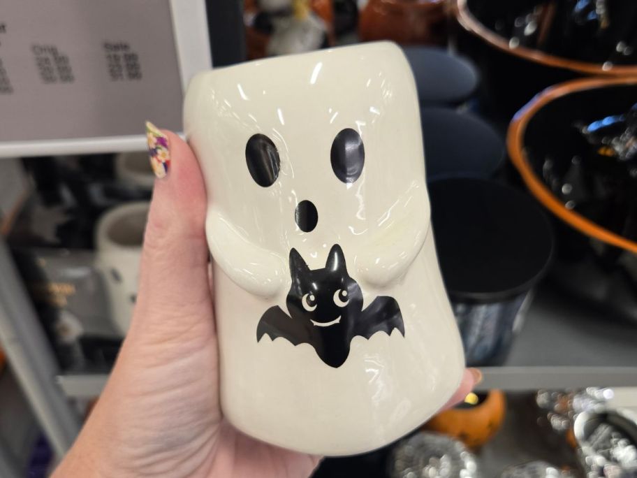 Hand holding a Ghost Hallowen Candle at Kohl's