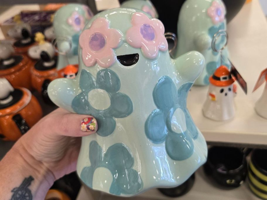 Hand holding a Celebrate Together Halloween Floral Ceramic Ghost