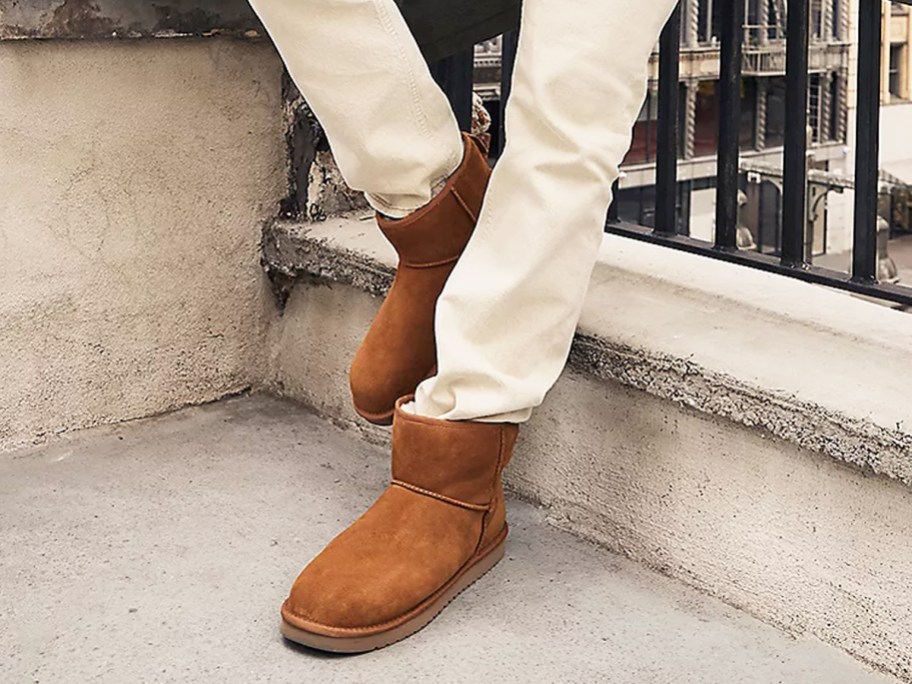 man in cream sweatpants and brown boots