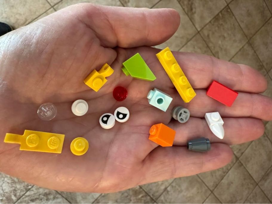 Hand holding a bunch of LEGOs