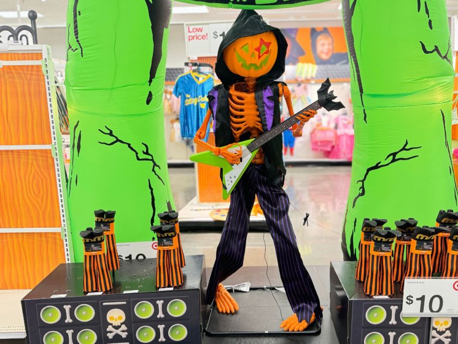 a pumpkin rocker singing skeleton on display in a target store