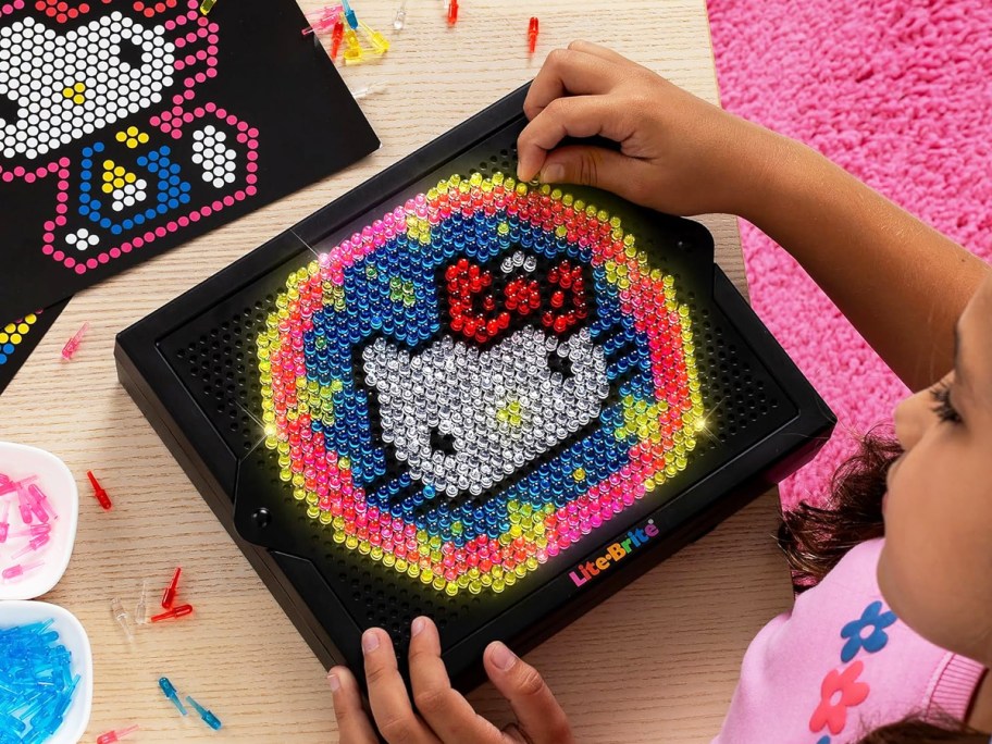 girl completing hello kitty lite brite design