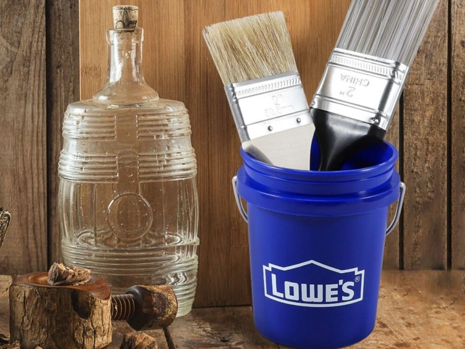 Lowes buckets iwth brushes inside next to bottle