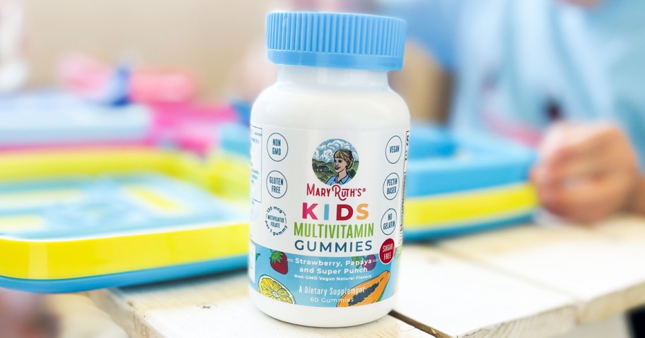 white and blue bottle of MaryRuth Organics Kids Multivitamin Gummies on table