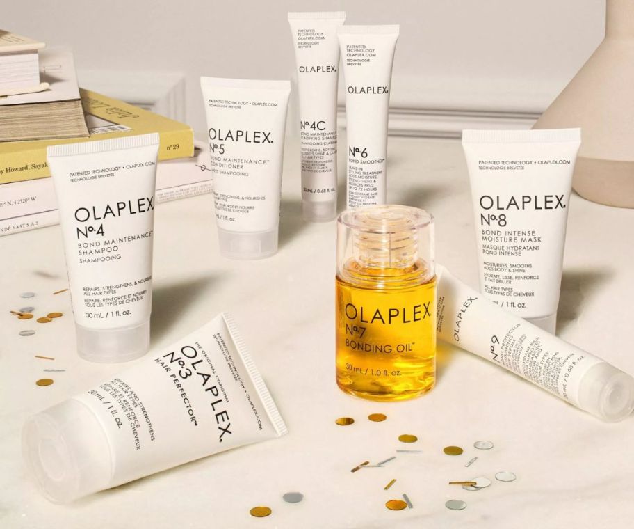 olaplex hair care products placed on a white table top strewn with gold and silver confetti