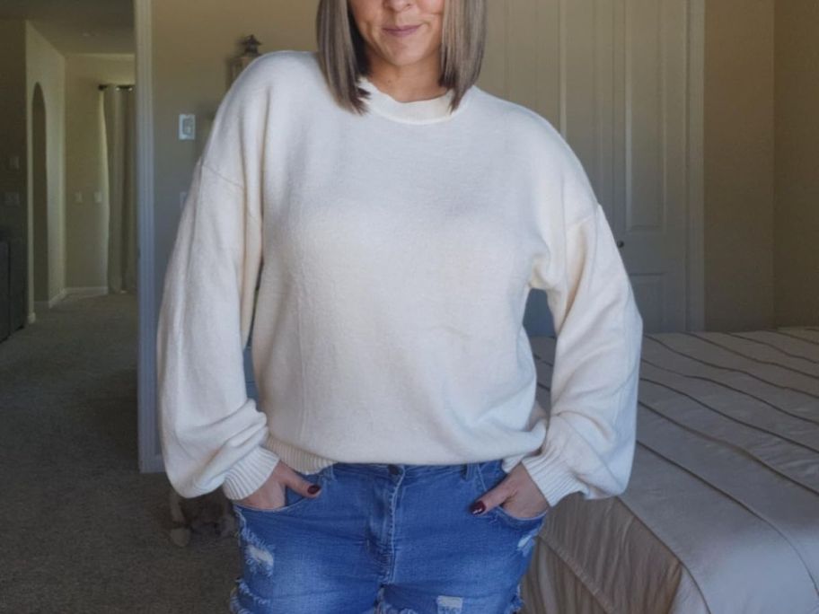 A woman wearing a white sweater