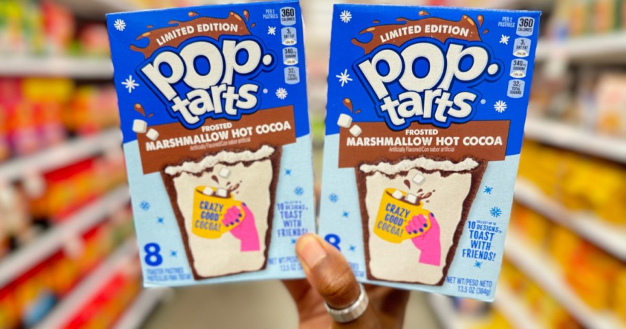 woman holding Pop Tarts Marhsmallow Hot Cocoa in Target store