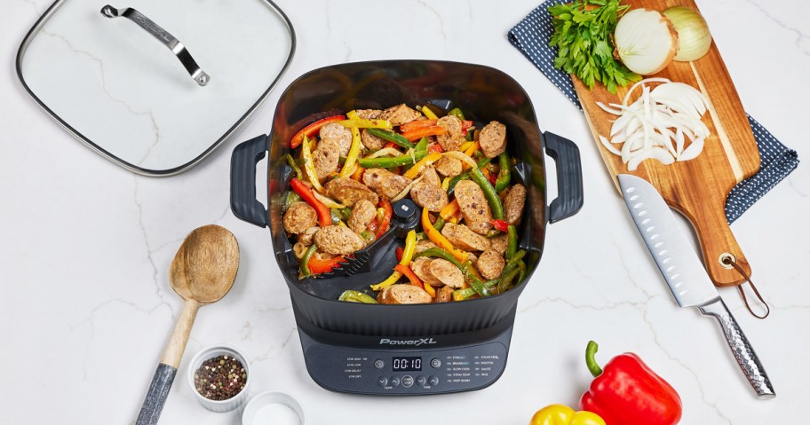 cooking sausage and peppers inside PowerXL StirMax 7.5-Quart Multi-Cooker on counter