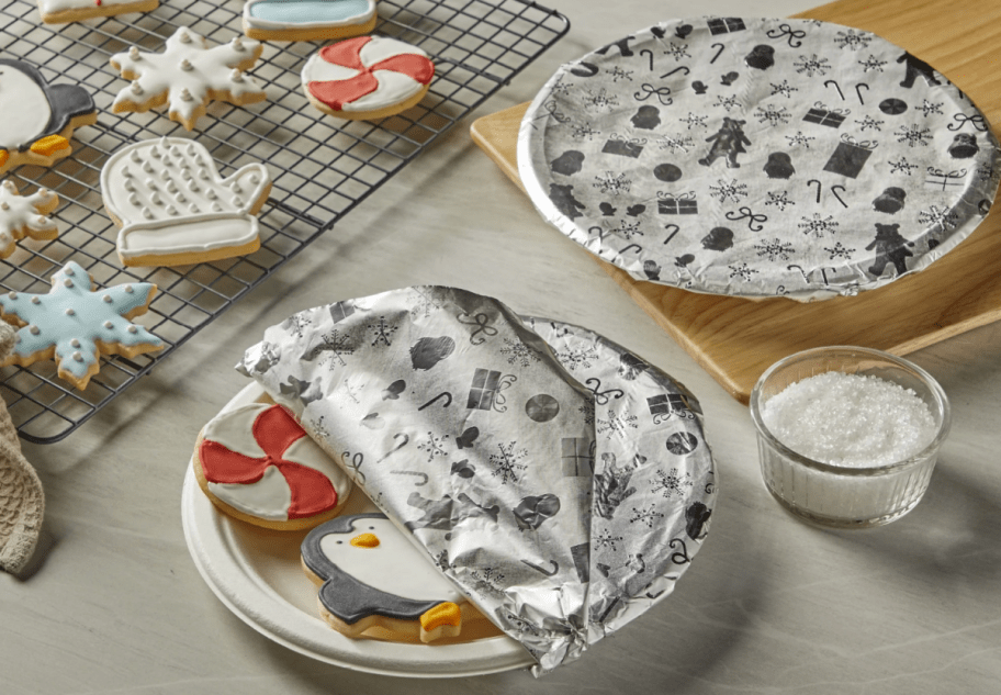 Reynolds Fun Foil with Holiday Patterns covering plates of Christmas cookies