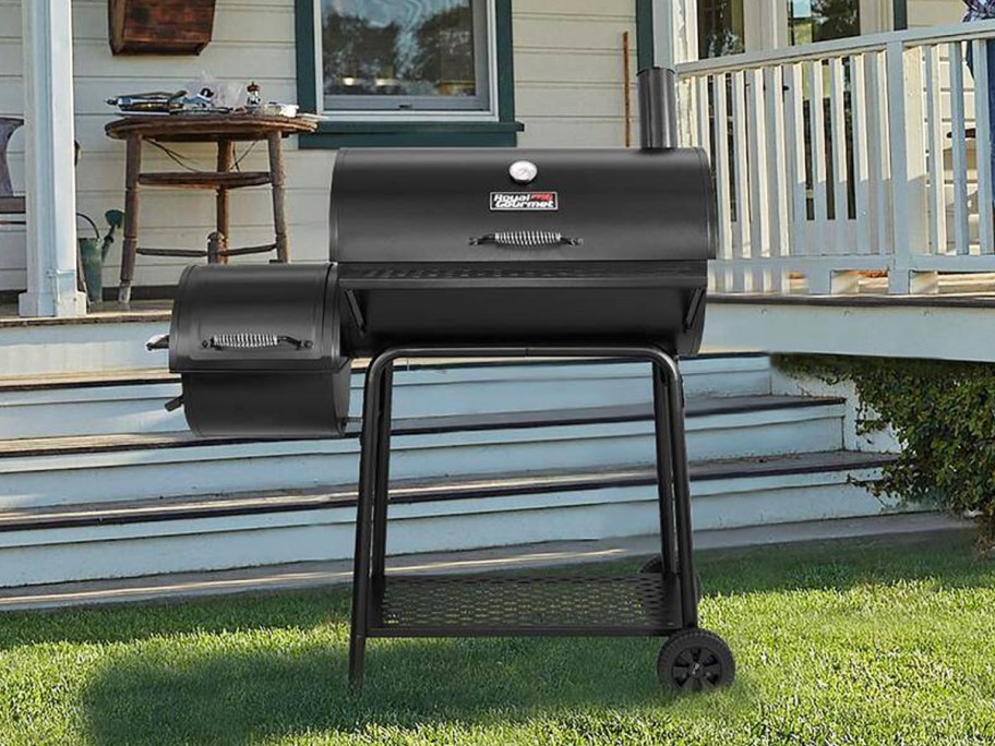 black charcoal grill with small smoker attached