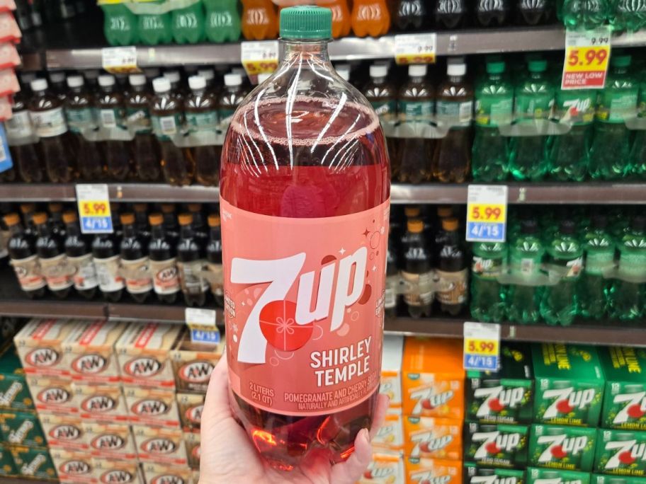 Hand holding a 2-liter Bottle of Shirley Temple 7-Up