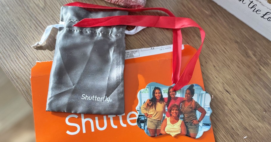 photo ornament and bag on top of orange shutterfly envelope