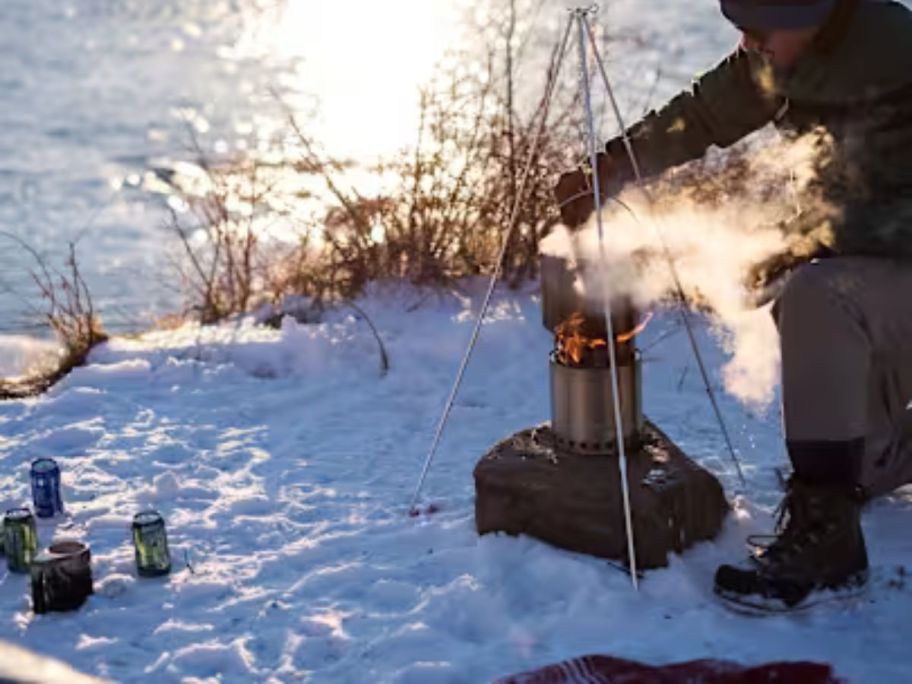 Solo Stove Campfire Gear Kit outside on snow with man using it