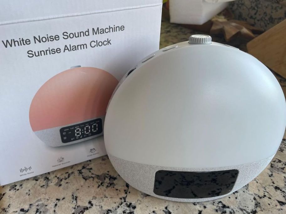 A Geuuap Sunrise Alarm Clock next to the box