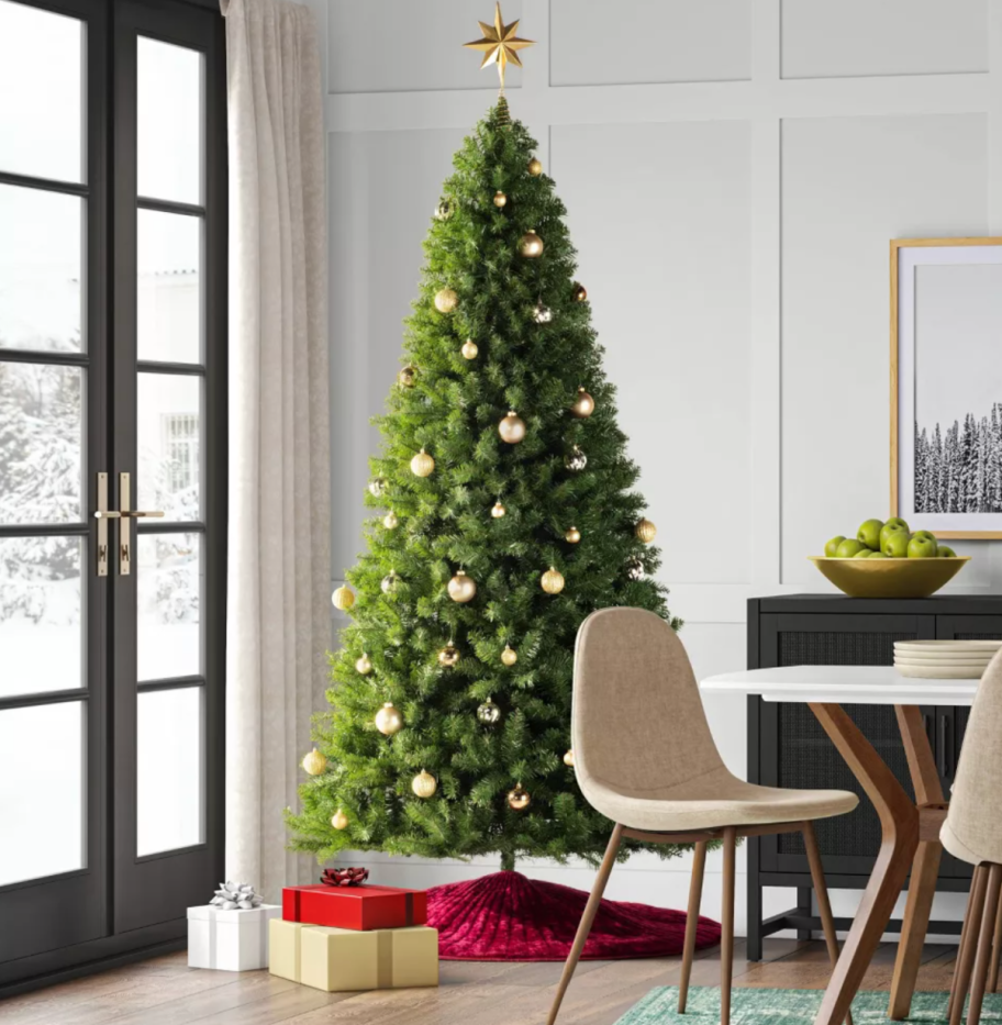 A full-size faux Christmas Tree from target set up in a living room