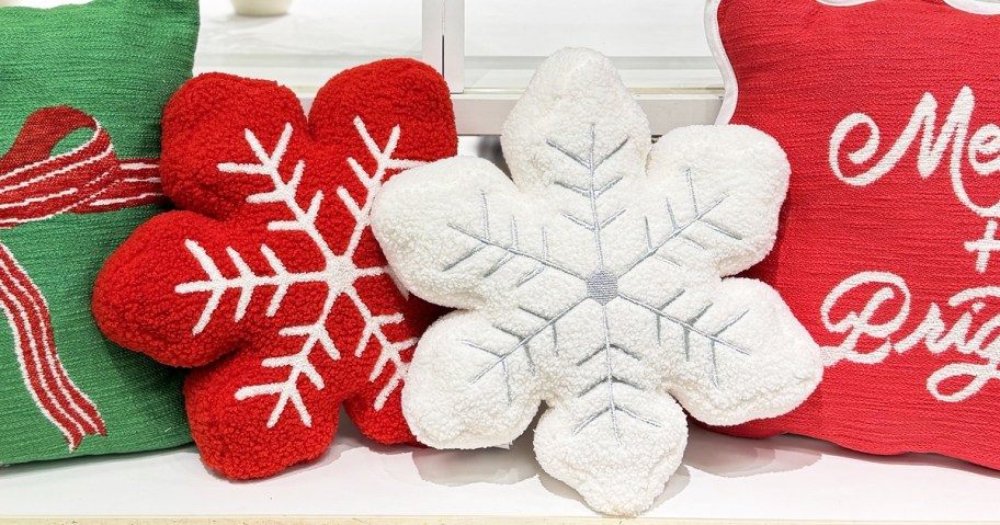 white and red snowflake pillows on display in store