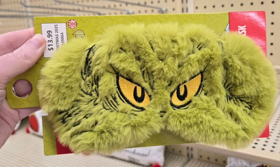 The Grinch Eye Mask being held