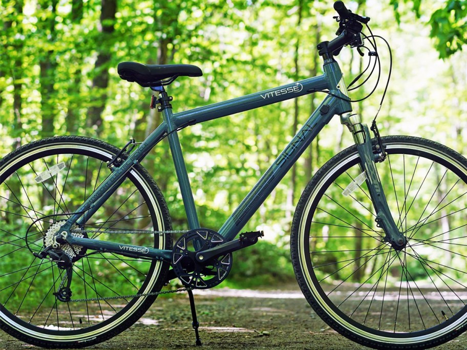 blue bike parked on trail