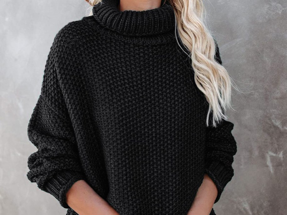 Woman-wearing-long-sleeve-sweater-in-black