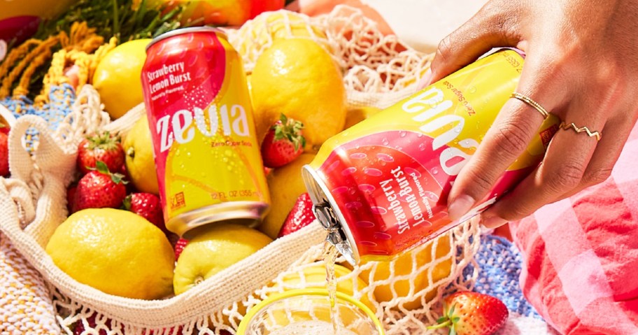 hand pouring a can of Zevia Strawberry Lemon Burst Soda
