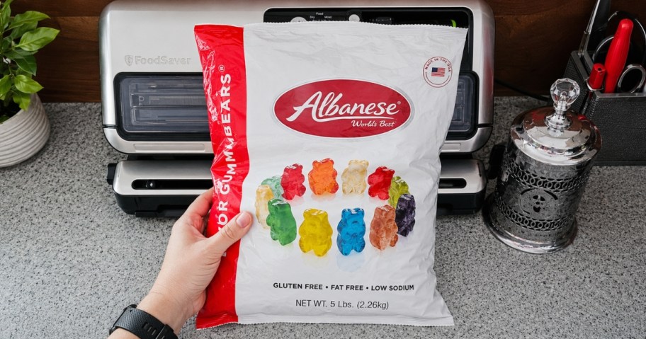 hand holding a large bag of Albanese Gummi Bears 