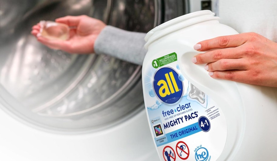 woman holding a tb of all mighty pacs and tossing one into a washing machine