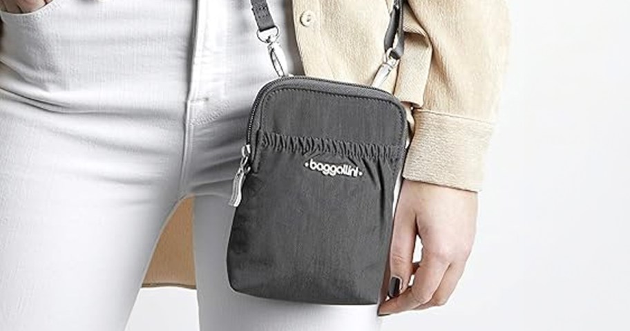 woman wearing gray baggallini crossbody bag 