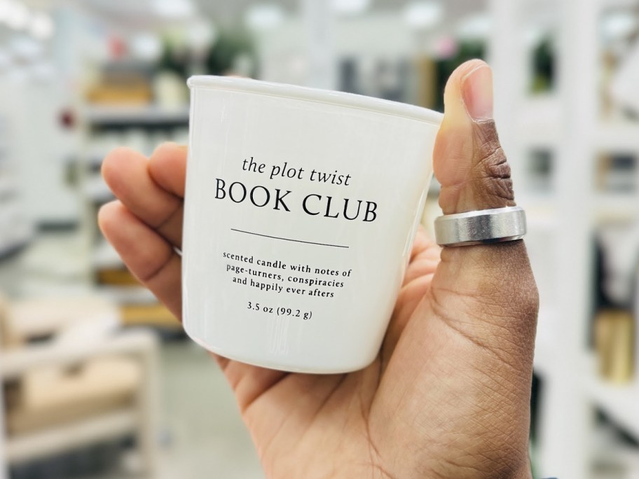 hand holding book club candle 