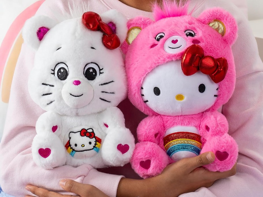 girl holding white and pink care bears