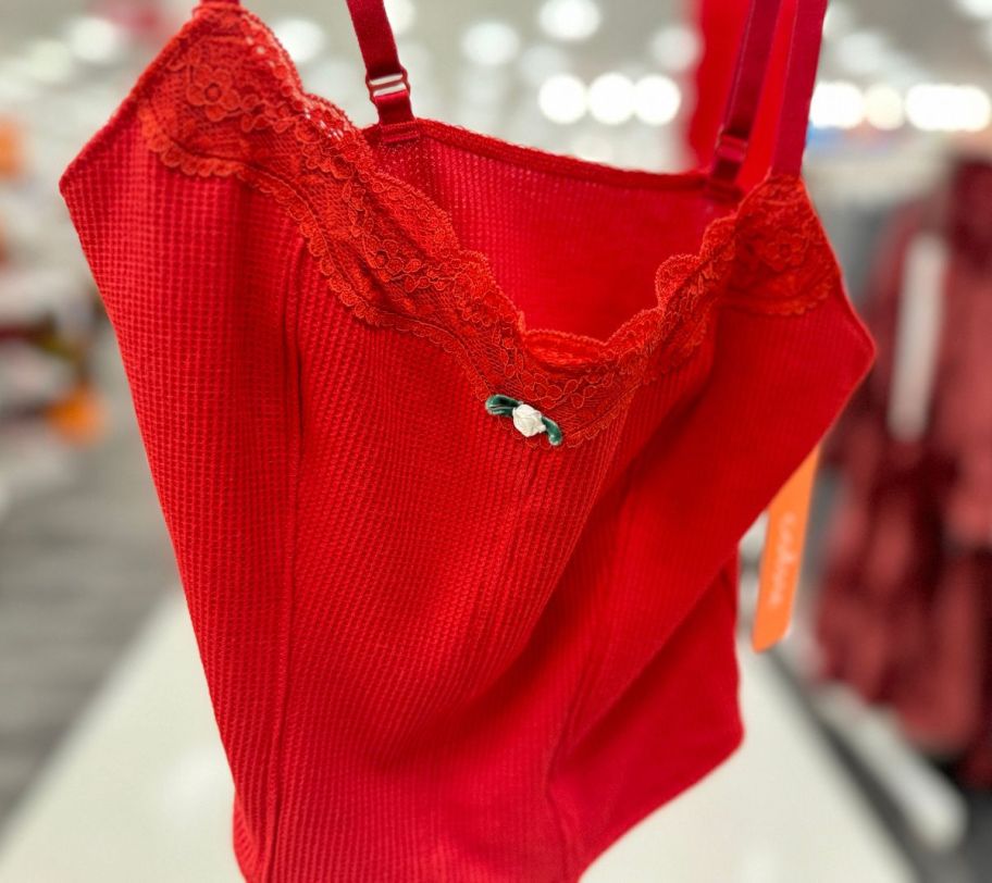 a red colsie brami top on a hanger in a store