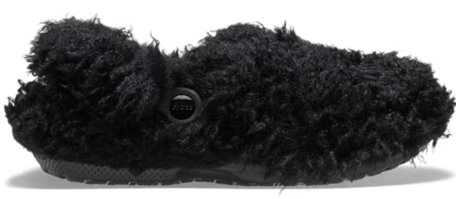 a Crocs clog with black faux dog like fur on the outside and inside