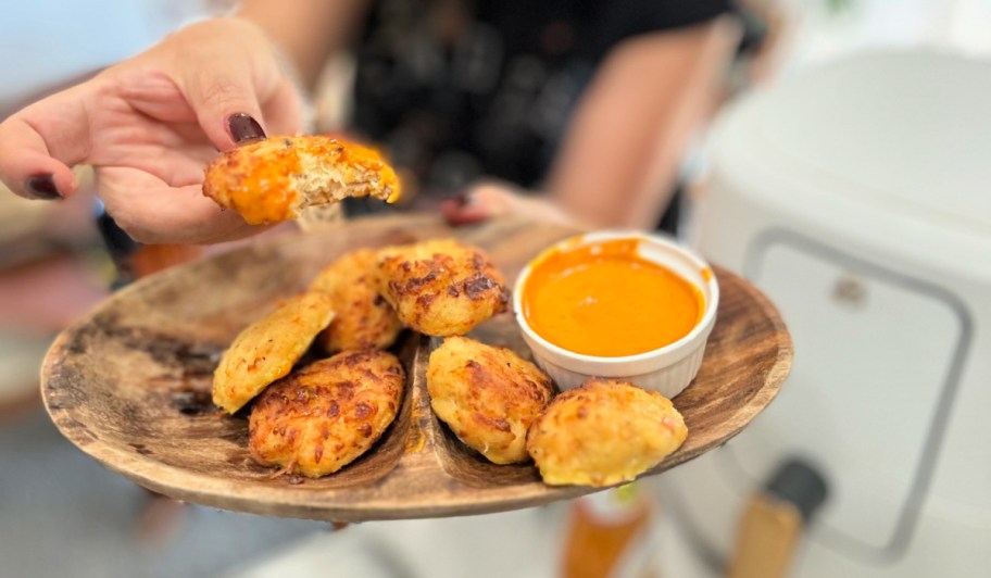 dipping homemade nuggets in sauce