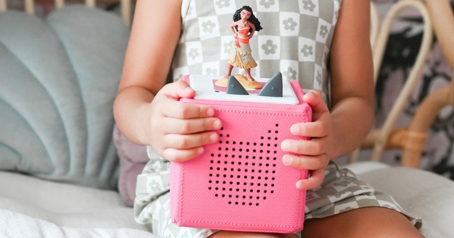 kid holding pink tonies box with moana on top 